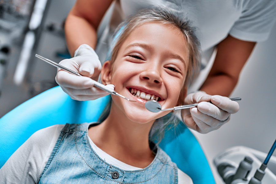 girl smiling during dental checkup